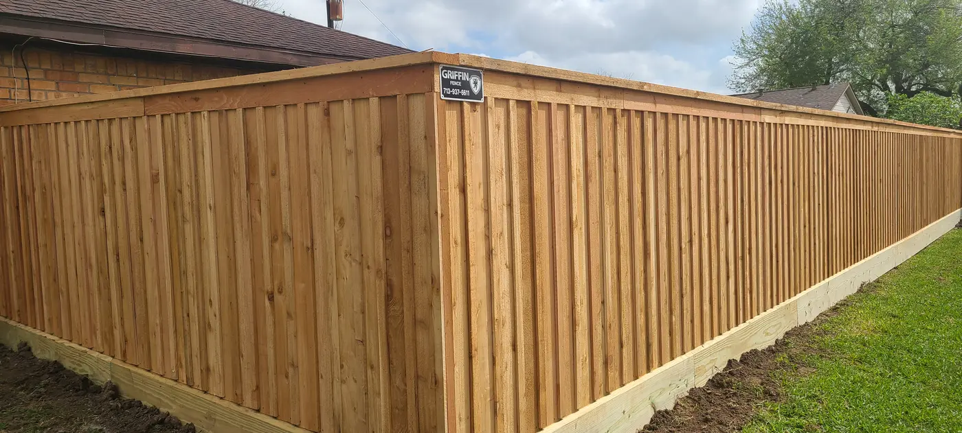 Batten board cedar fence with cap rail and baseboard installed by Griffin Fence Houston TX